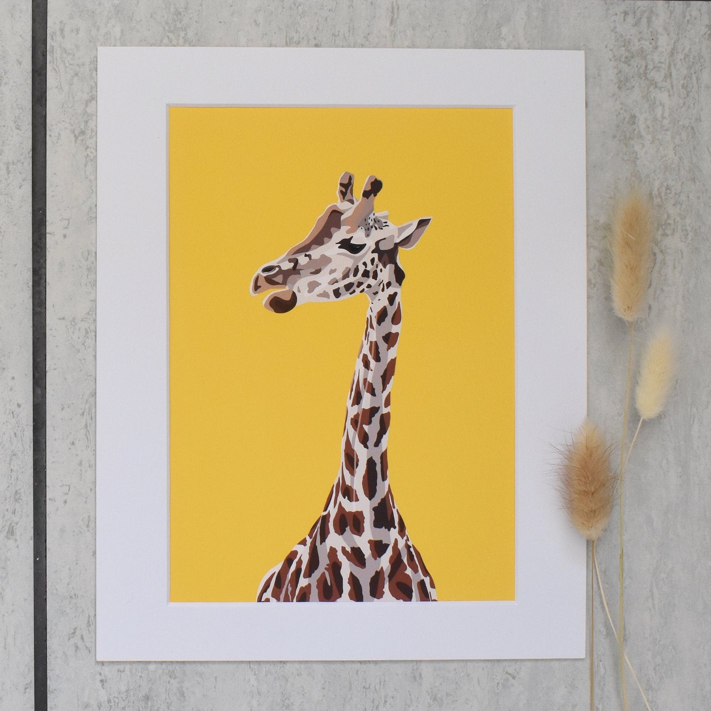 Giraffe illustration on a yellow background with a white border, placed on a textured surface.