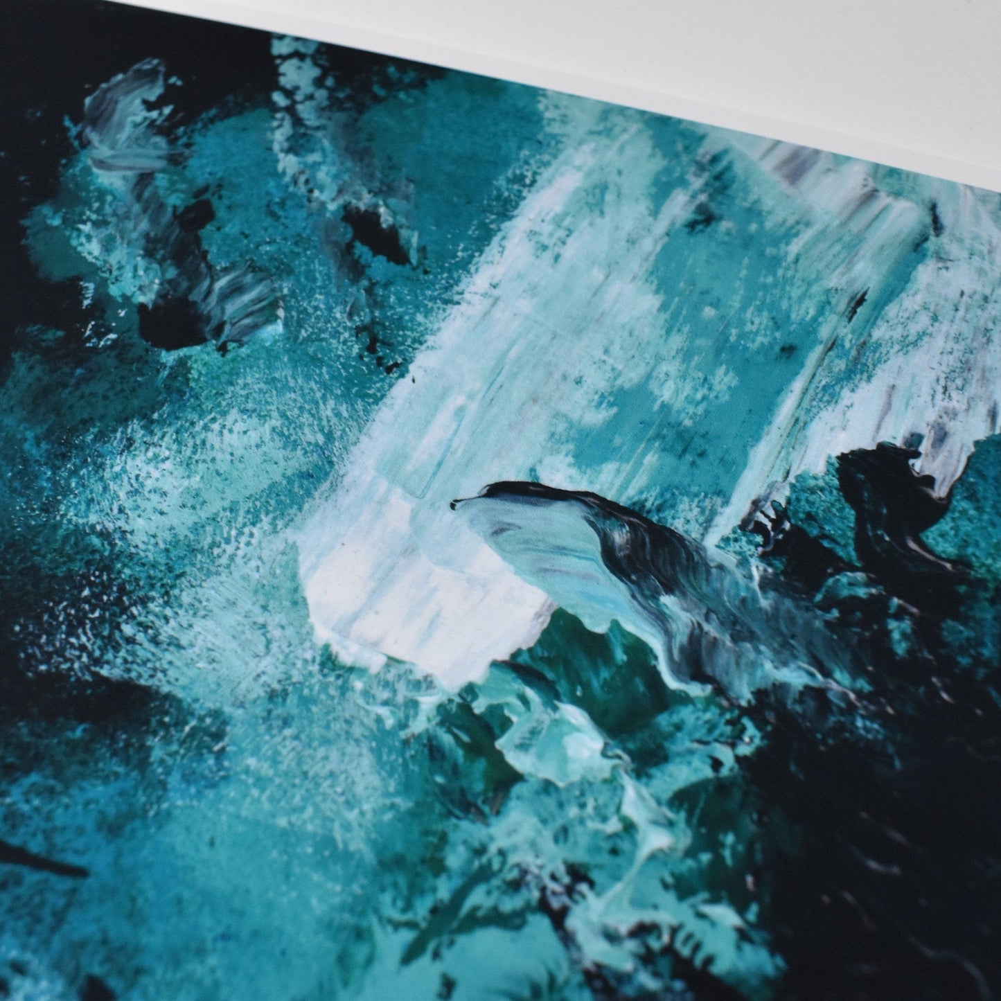 Abstract art piece with blue and black colors on a white background