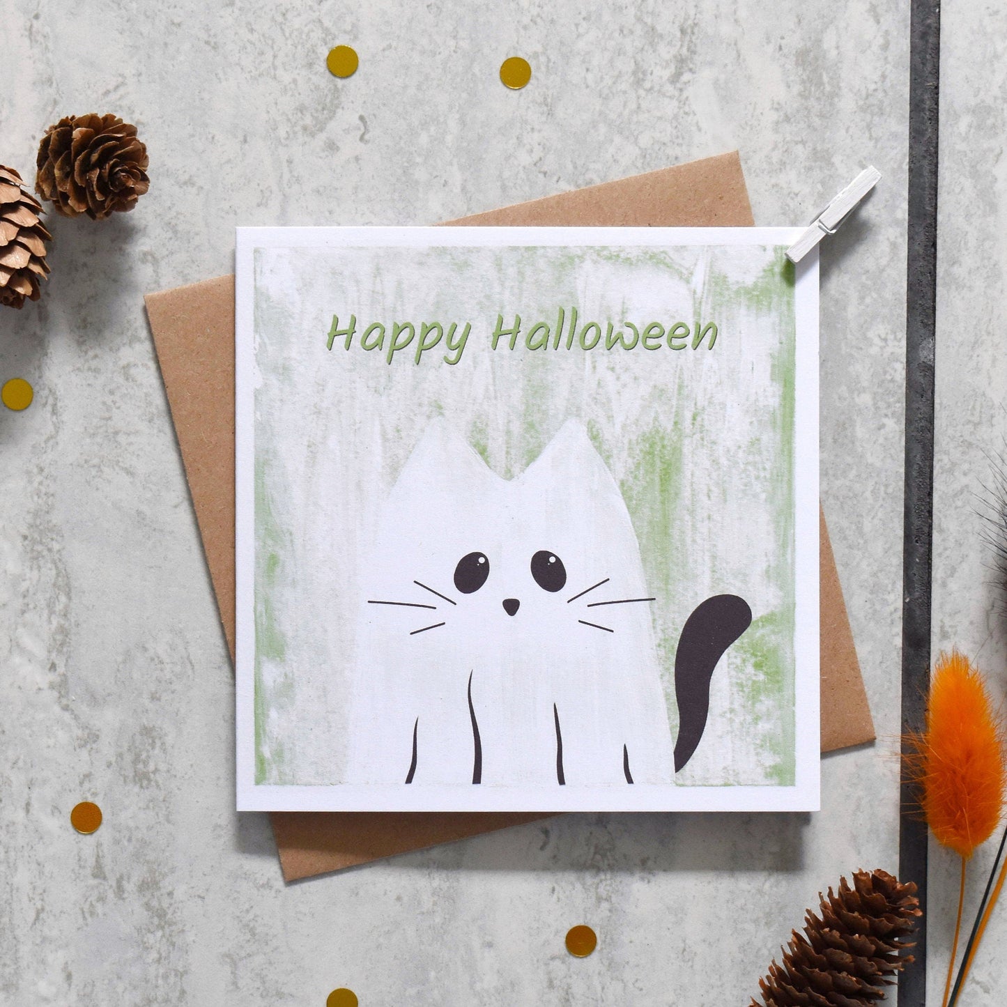 Halloween card with a cat illustration and 'Happy Halloween' text on a textured surface.