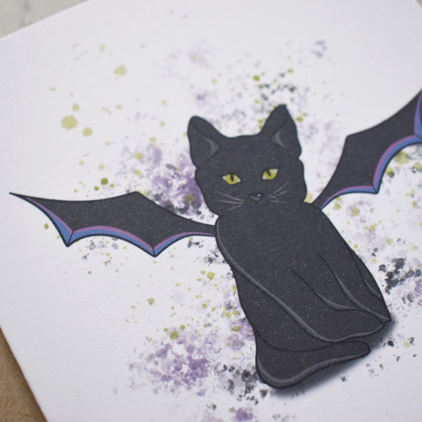 Black cat with bat wings on a greeting card with a floral pattern