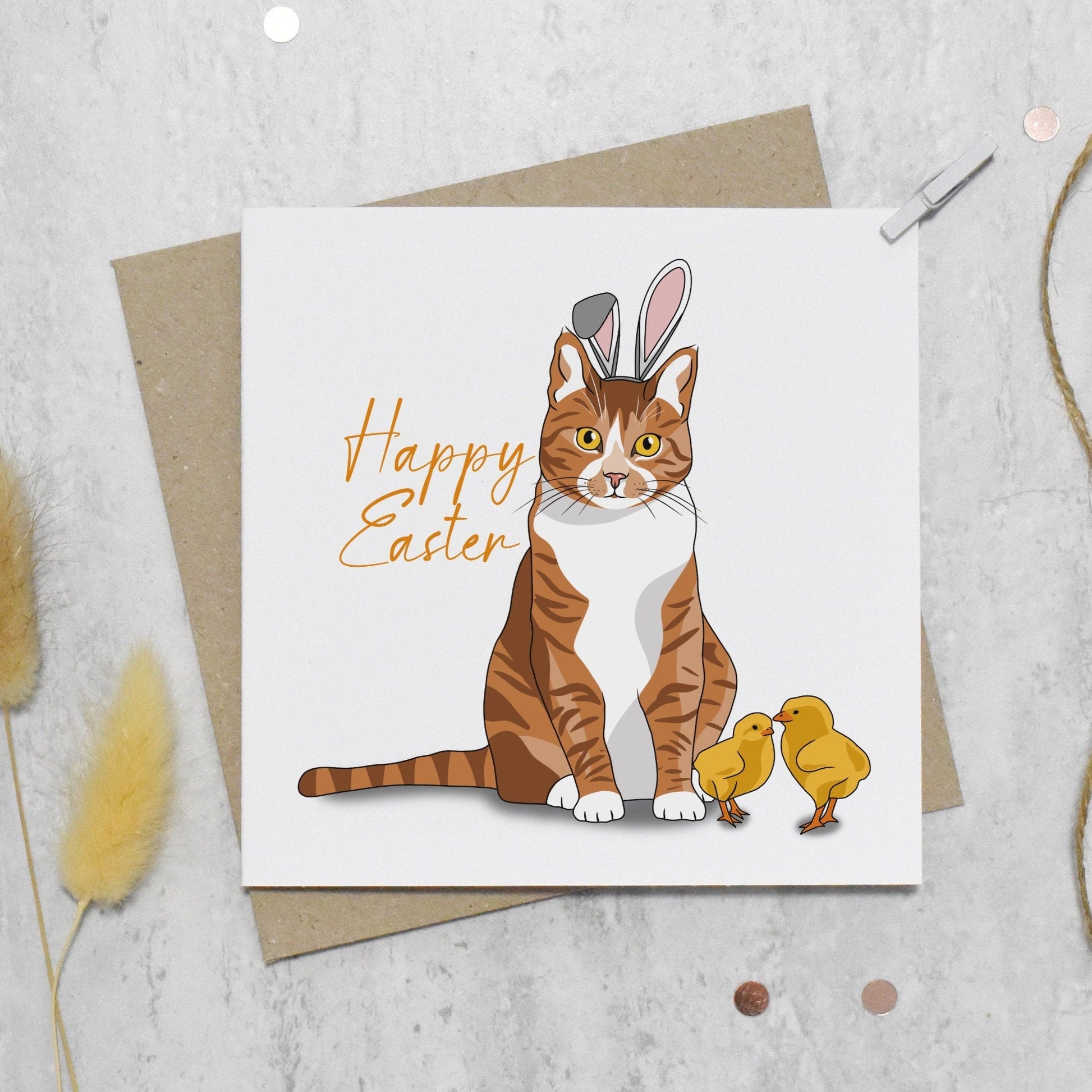 Easter card with a cat wearing bunny ears and holding chicks on a textured surface.