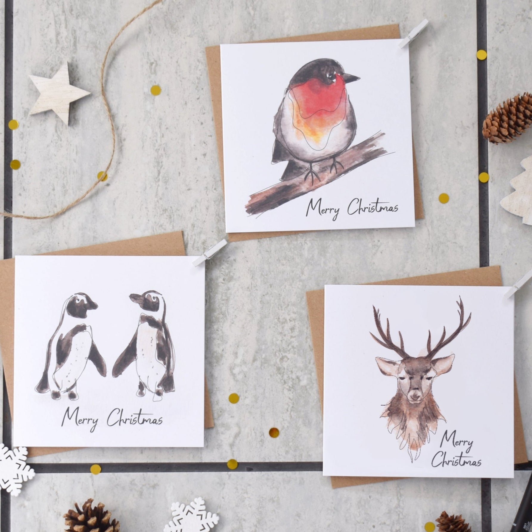 Set of Christmas cards with animal illustrations on a textured surface.