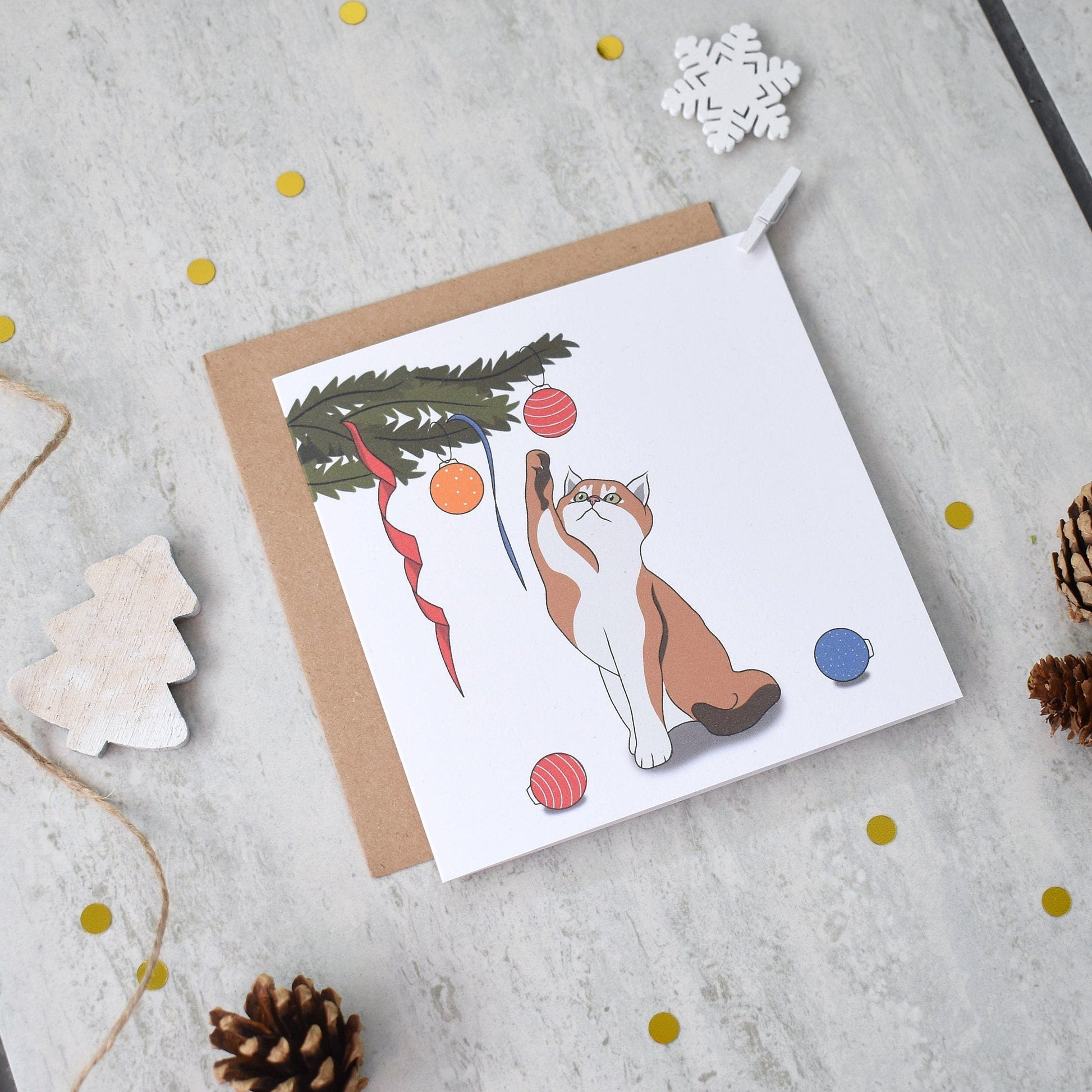 Greeting card with a cat illustration on a textured surface with decorative elements.