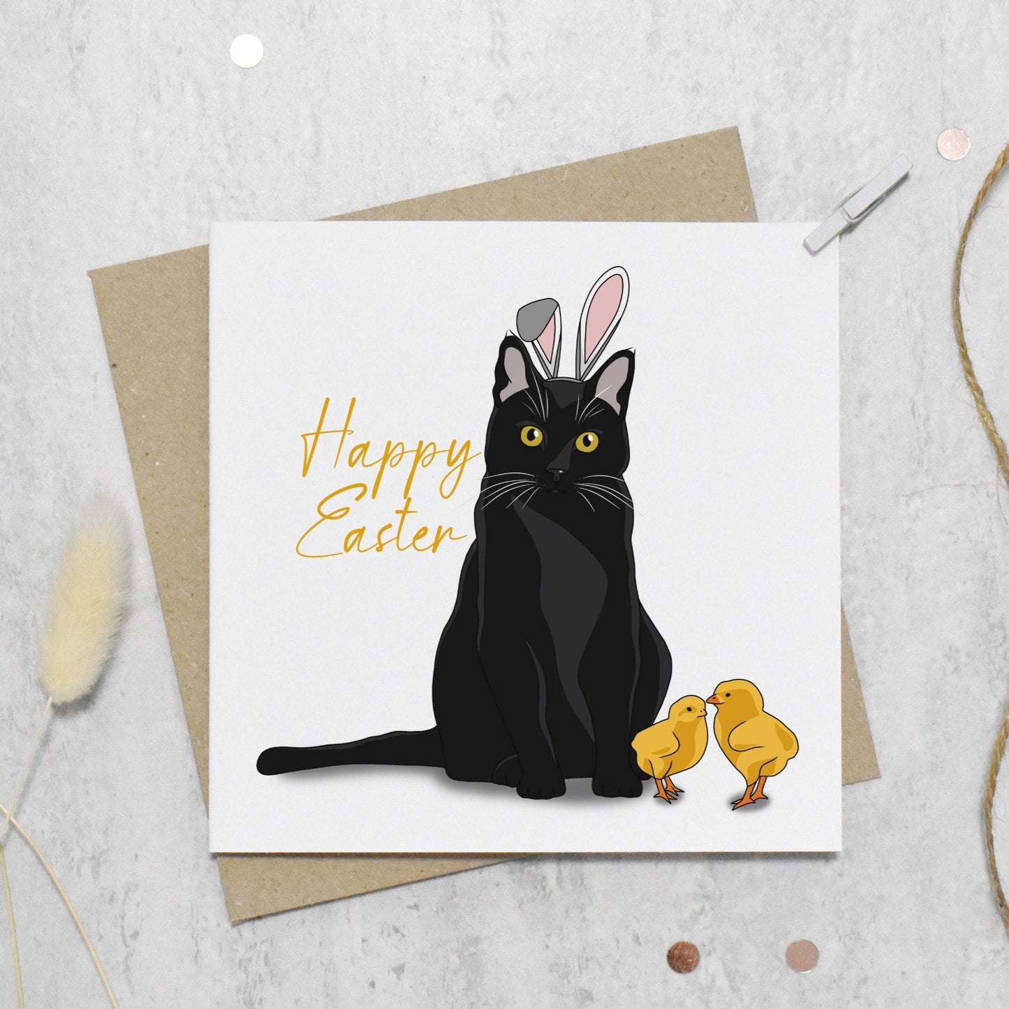 Easter card with a black cat wearing bunny ears and two chicks on a textured surface.