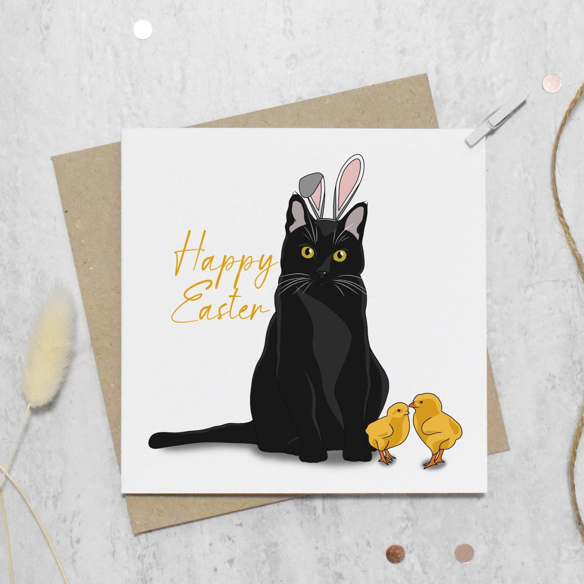 Easter card with a black cat wearing bunny ears and two chicks on a textured surface.