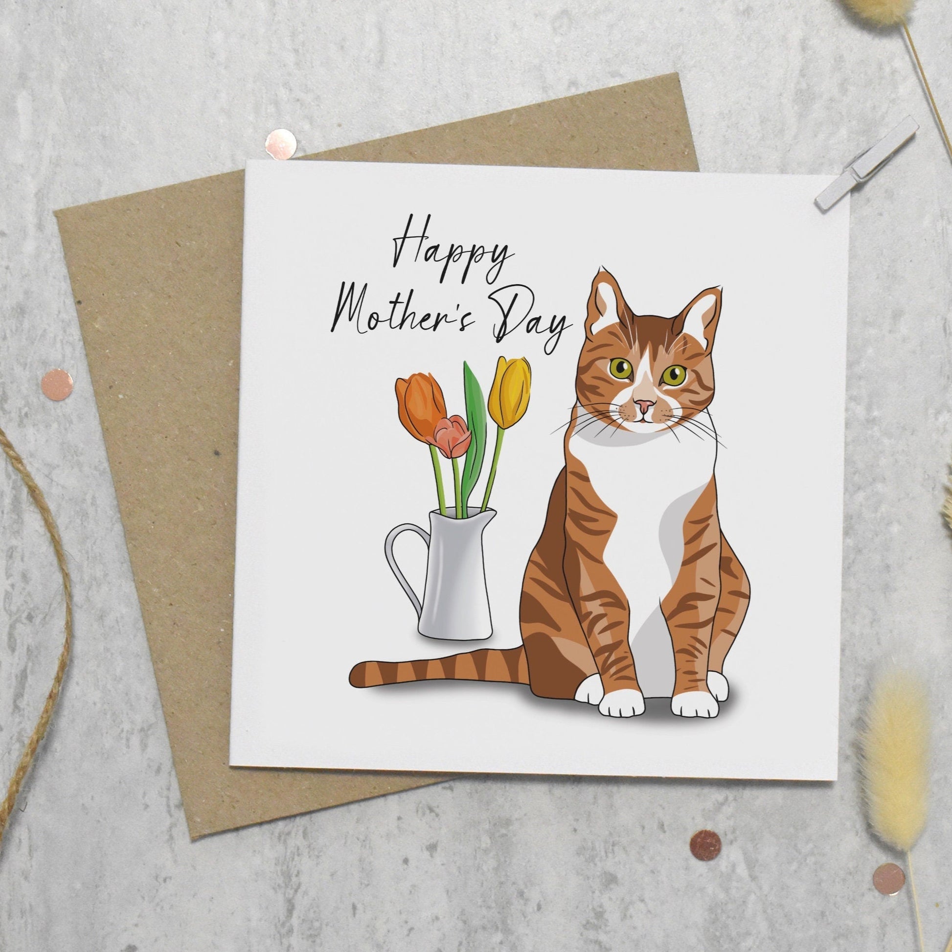 Mother's Day card with a cat illustration and flowers on a textured surface.