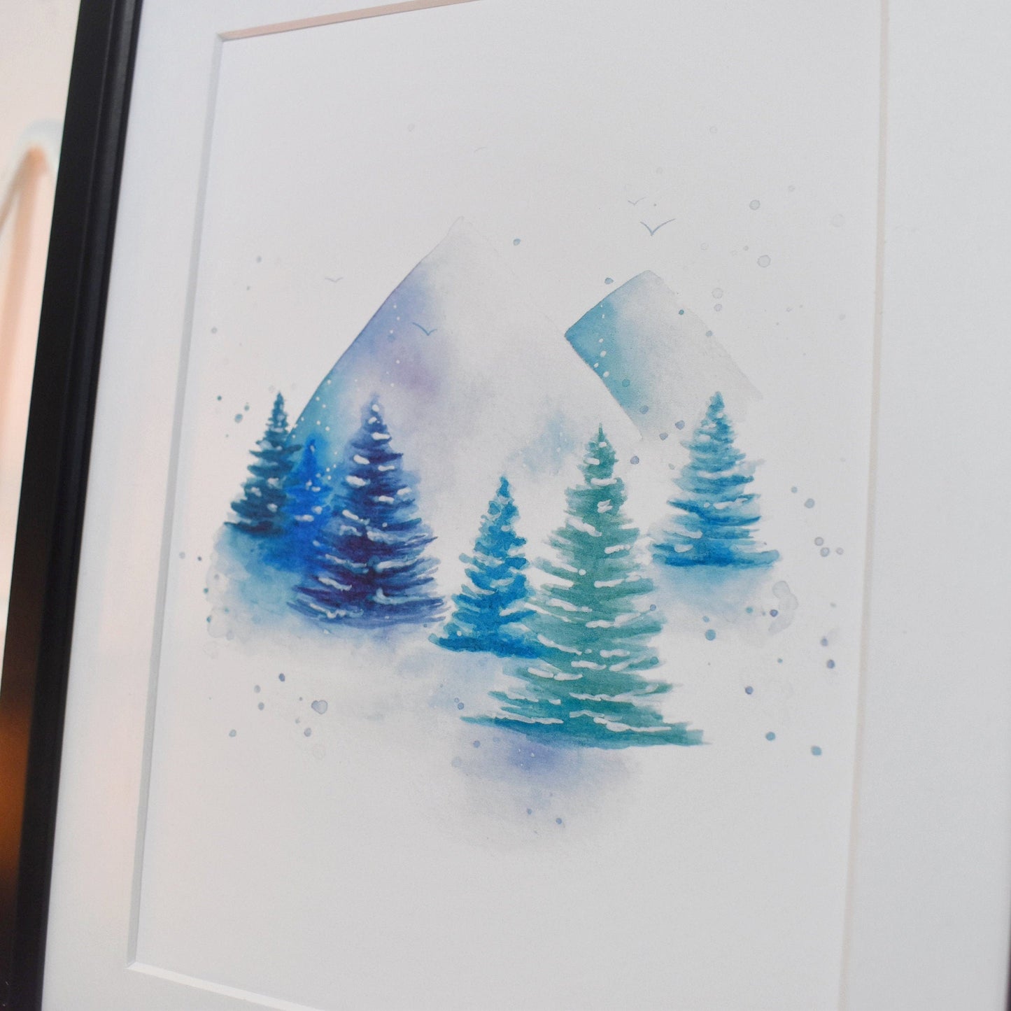 Framed watercolor painting of trees on a white background